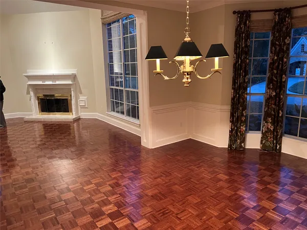 a view of an empty room with a fireplace and a rug
