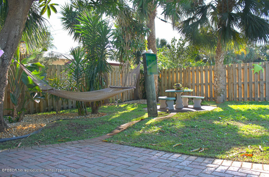 216 Costello Road West Palm Beach, FL 33405 - Photo 12 of 25 a garden with trees in front of it