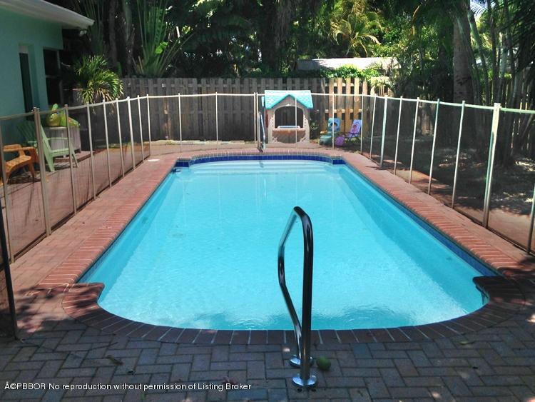 216 Costello Road West Palm Beach, FL 33405 - Photo 14 of 25 a view of a swimming pool with a porch and furniture