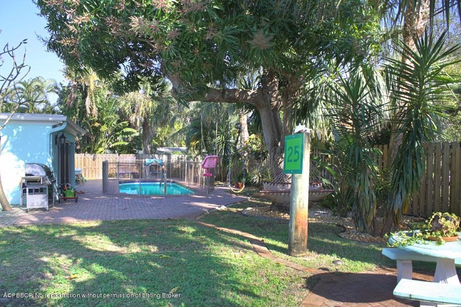 216 Costello Road West Palm Beach, FL 33405 - Photo 16 of 25 a view of a backyard with plants and patio