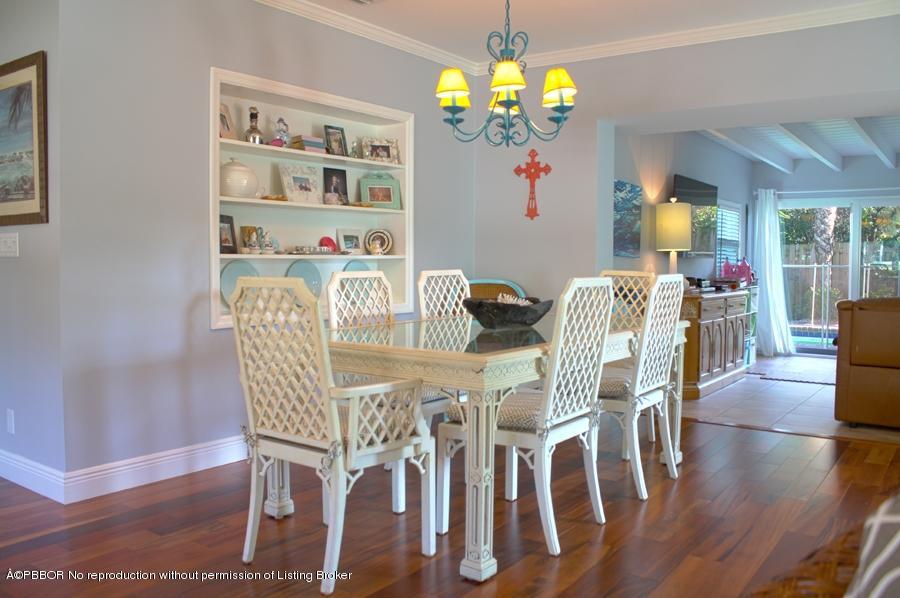 216 Costello Road West Palm Beach, FL 33405 - Photo 21 of 25 a view of a dining room with furniture wooden floor and chandelier