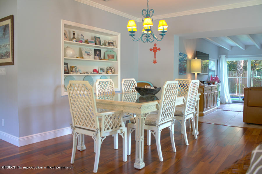 216 Costello Road West Palm Beach, FL 33405 - Photo 4 of 25 a view of a dining room with furniture wooden floor and chandelier