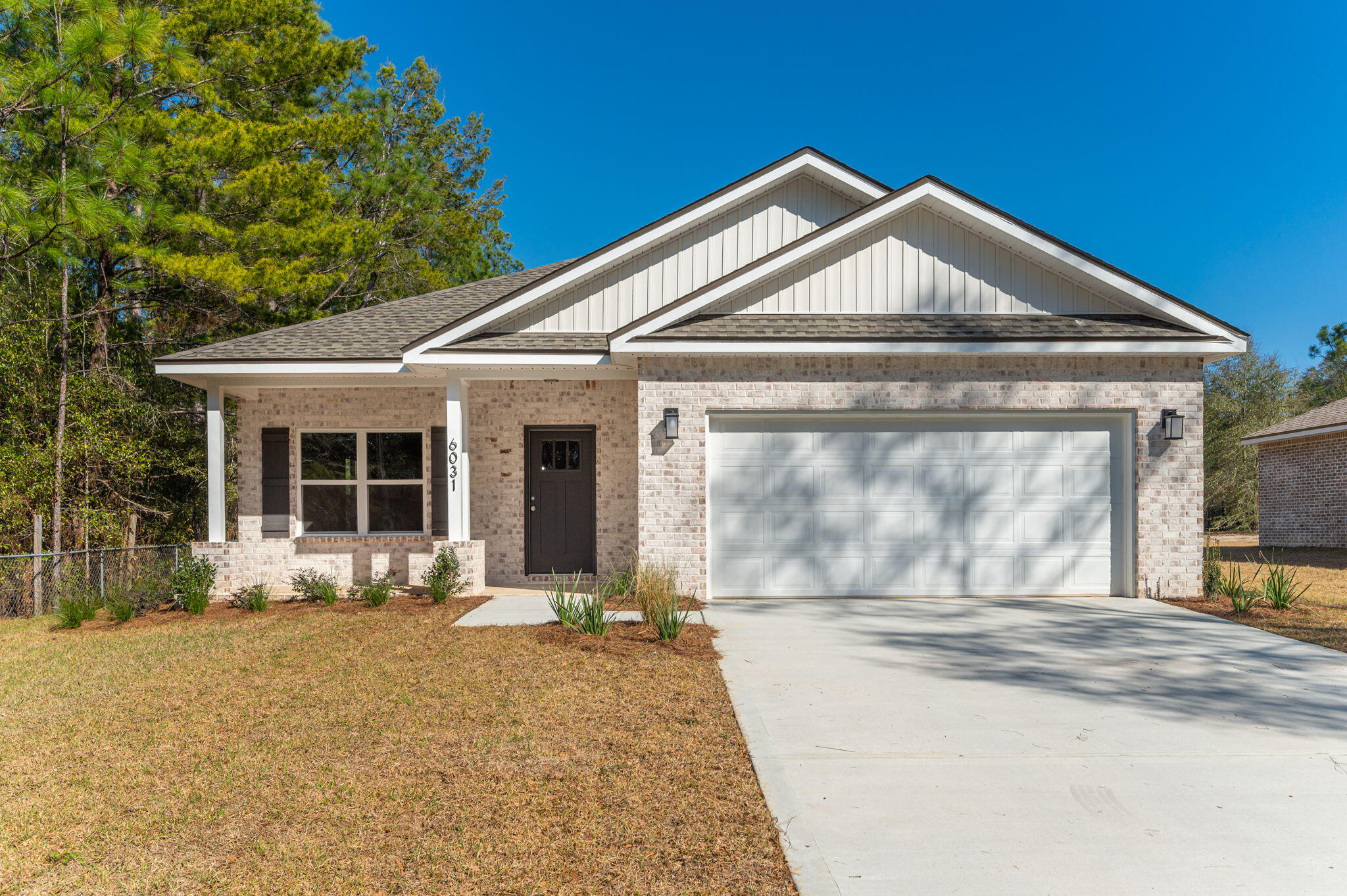 6031 Sand Hill Road Crestview, FL 32539 - Photo 1 of 11 a front view of a house with a yard and garage