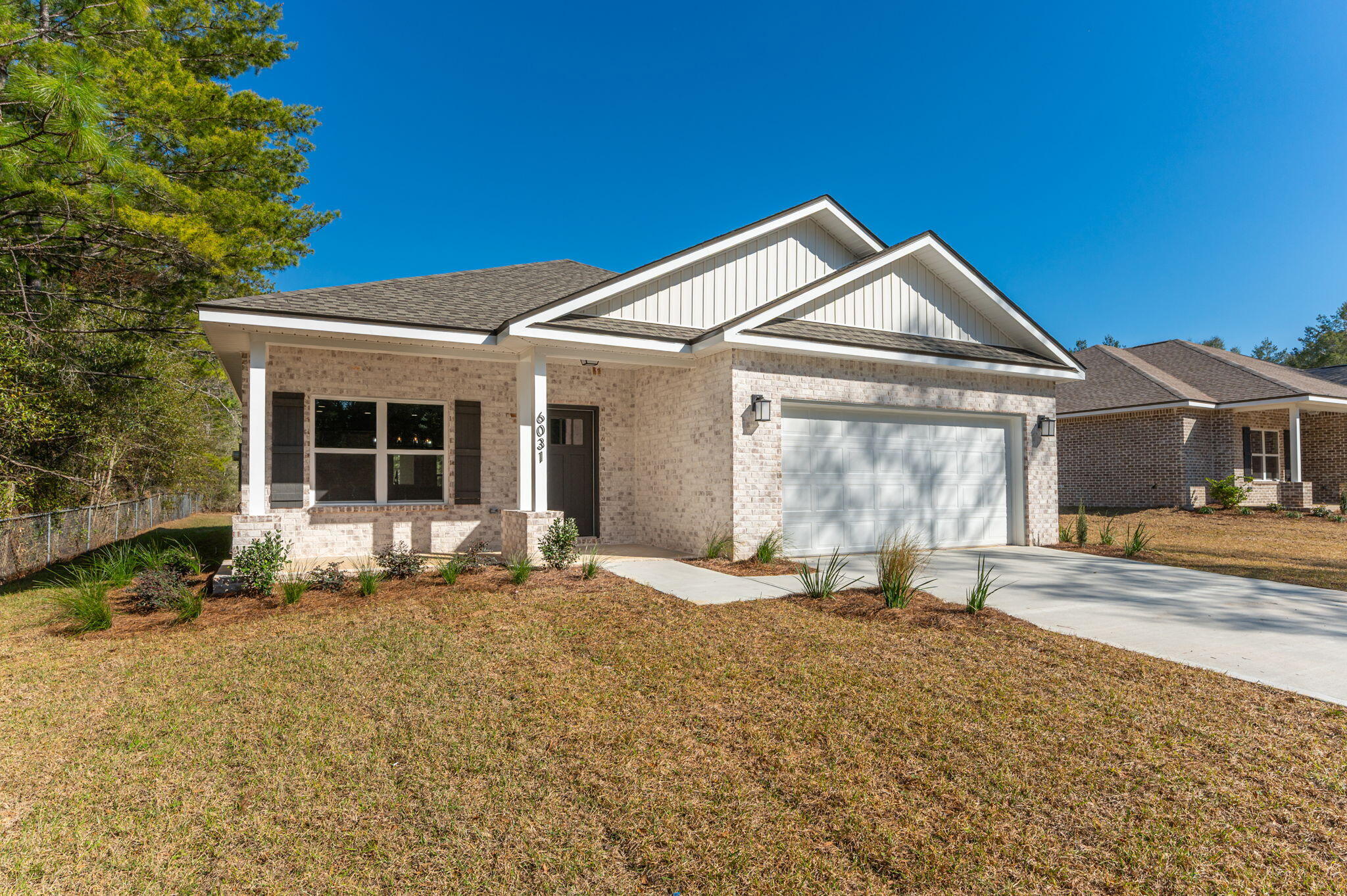 6031 Sand Hill Road Crestview, FL 32539 - Photo 3 of 11 a front view of a house with a yard