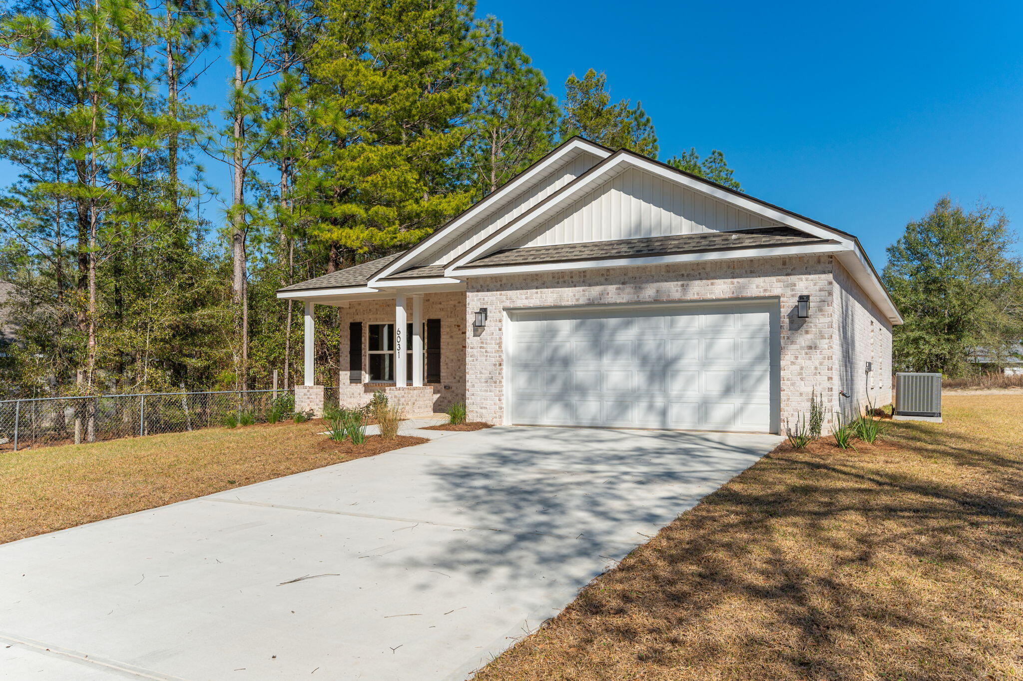 6031 Sand Hill Road Crestview, FL 32539 - Photo 4 of 11 a front view of a house with a garden