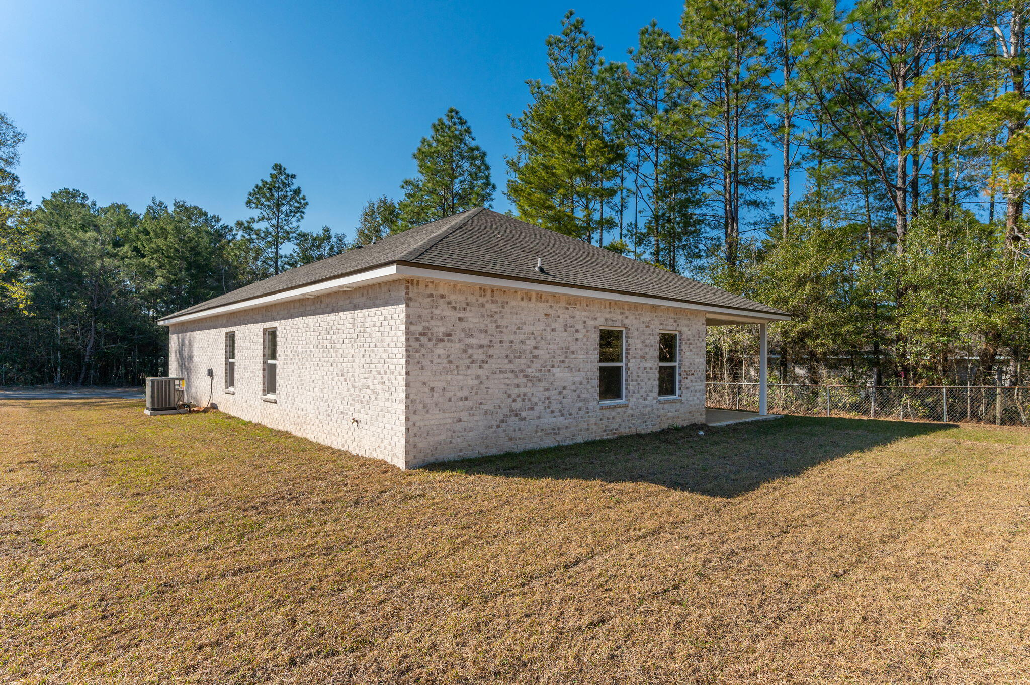 6031 Sand Hill Road Crestview, FL 32539 - Photo 7 of 11 a front view of house with yard and trees around