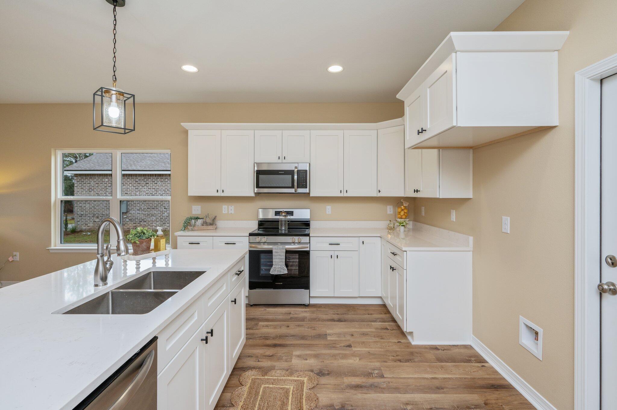 6031 Sand Hill Road Crestview, FL 32539 - Photo 10 of 11 a kitchen with cabinets a sink and appliances