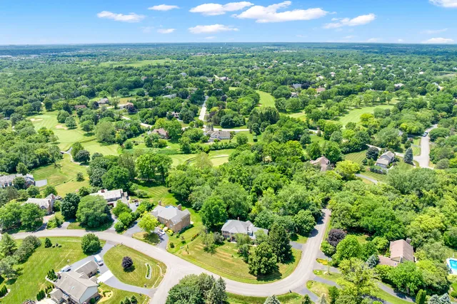 an aerial view of residential houses with outdoor space and street view