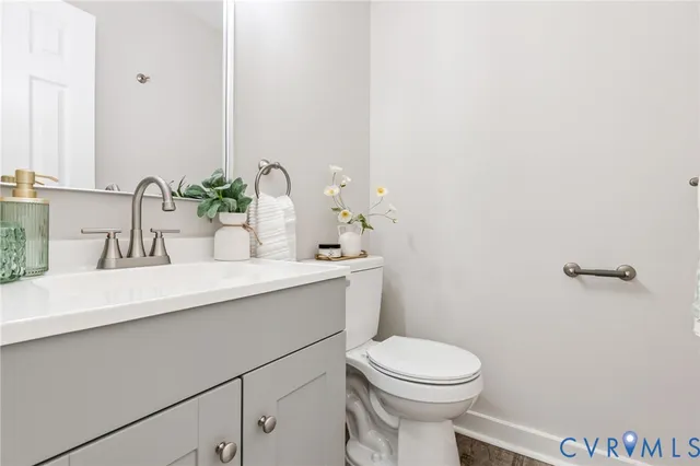 a bathroom with a sink a toilet and mirror