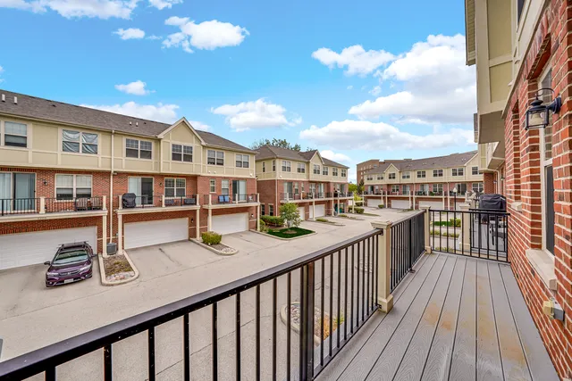 a view of a balcony with wooden floor and city view