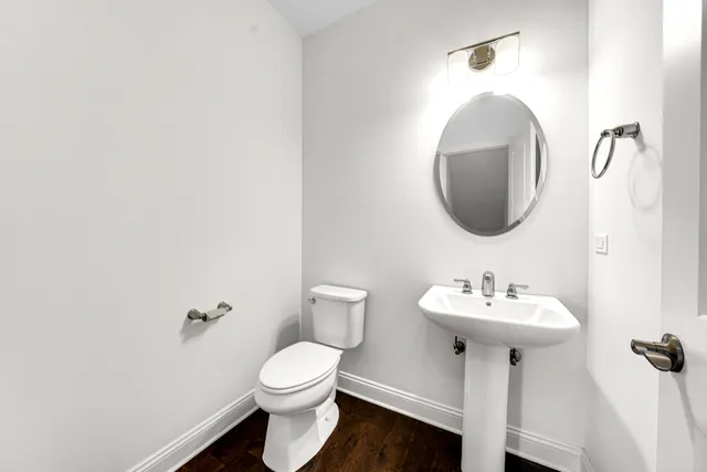 a bathroom with a sink toilet and a mirror