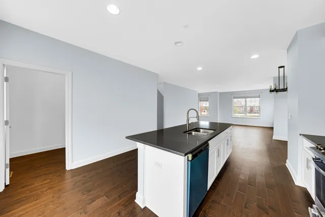 a kitchen that has a sink and a stove in it
