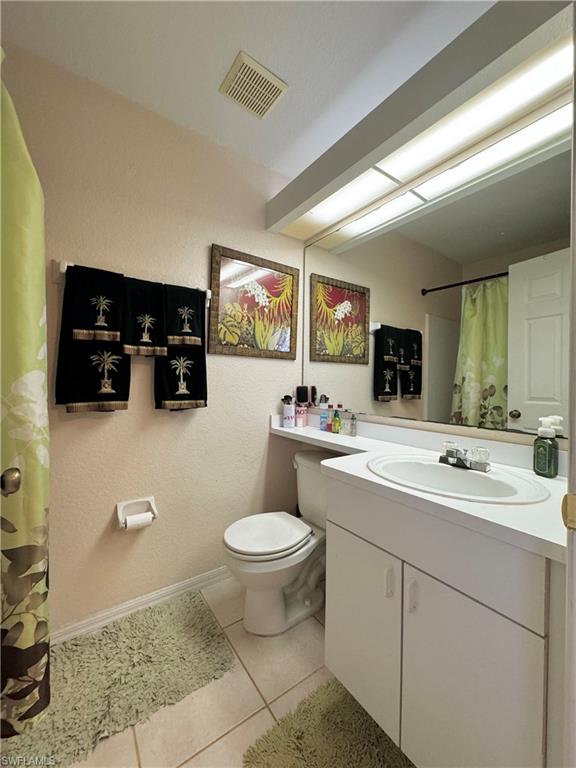 3435 Randall Boulevard Naples, FL 34120 - Photo 14 of 20 a bathroom with a toilet a sink and mirror