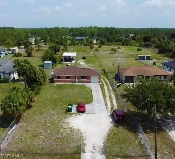 3435 Randall Boulevard Naples, FL 34120 - Photo 2 of 20 an aerial view of a house with yard table and chairs