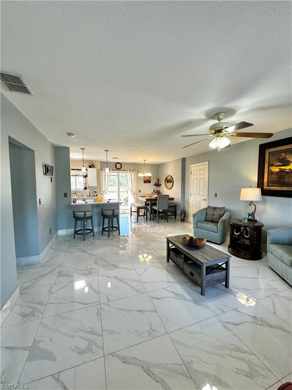 3435 Randall Boulevard Naples, FL 34120 - Photo 4 of 20 a living room with furniture and a flat screen tv