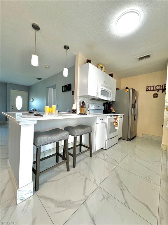 3435 Randall Boulevard Naples, FL 34120 - Photo 8 of 20 a kitchen with stainless steel appliances kitchen island granite countertop a sink and cabinets