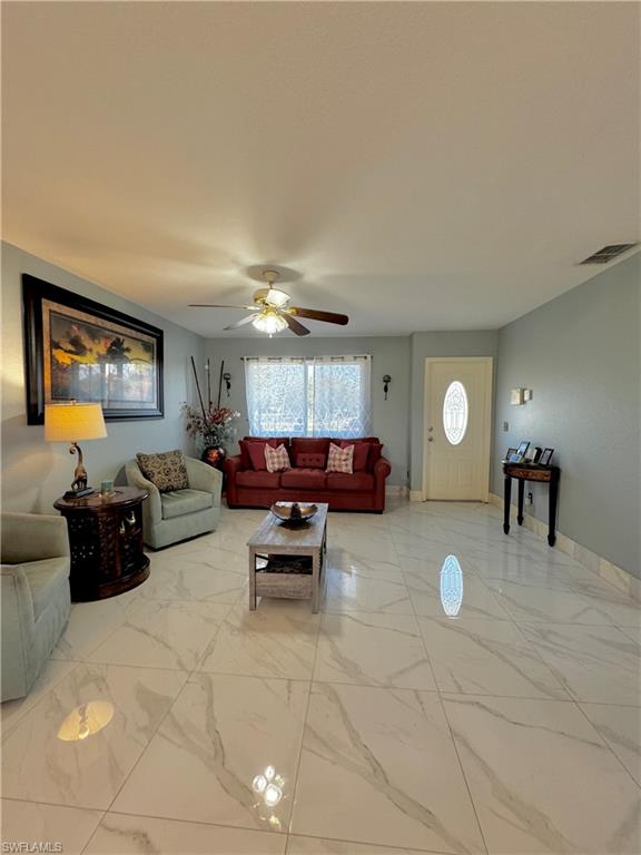 3435 Randall Boulevard Naples, FL 34120 - Photo 10 of 20 a living room with furniture and a wooden floor