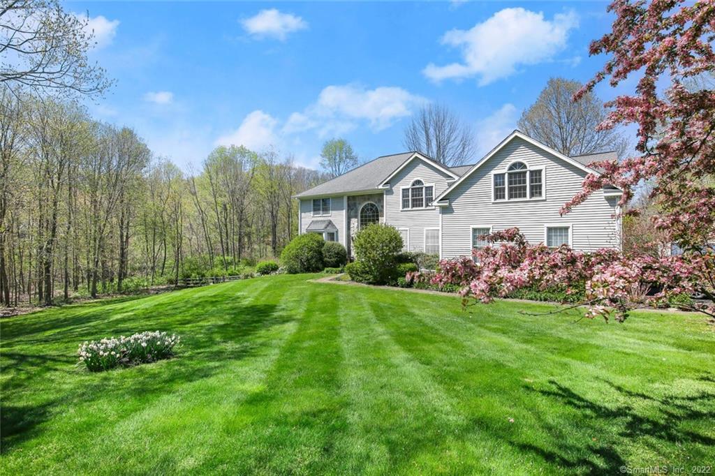 Gorgeous sweeping lawn surrounds this lovely home