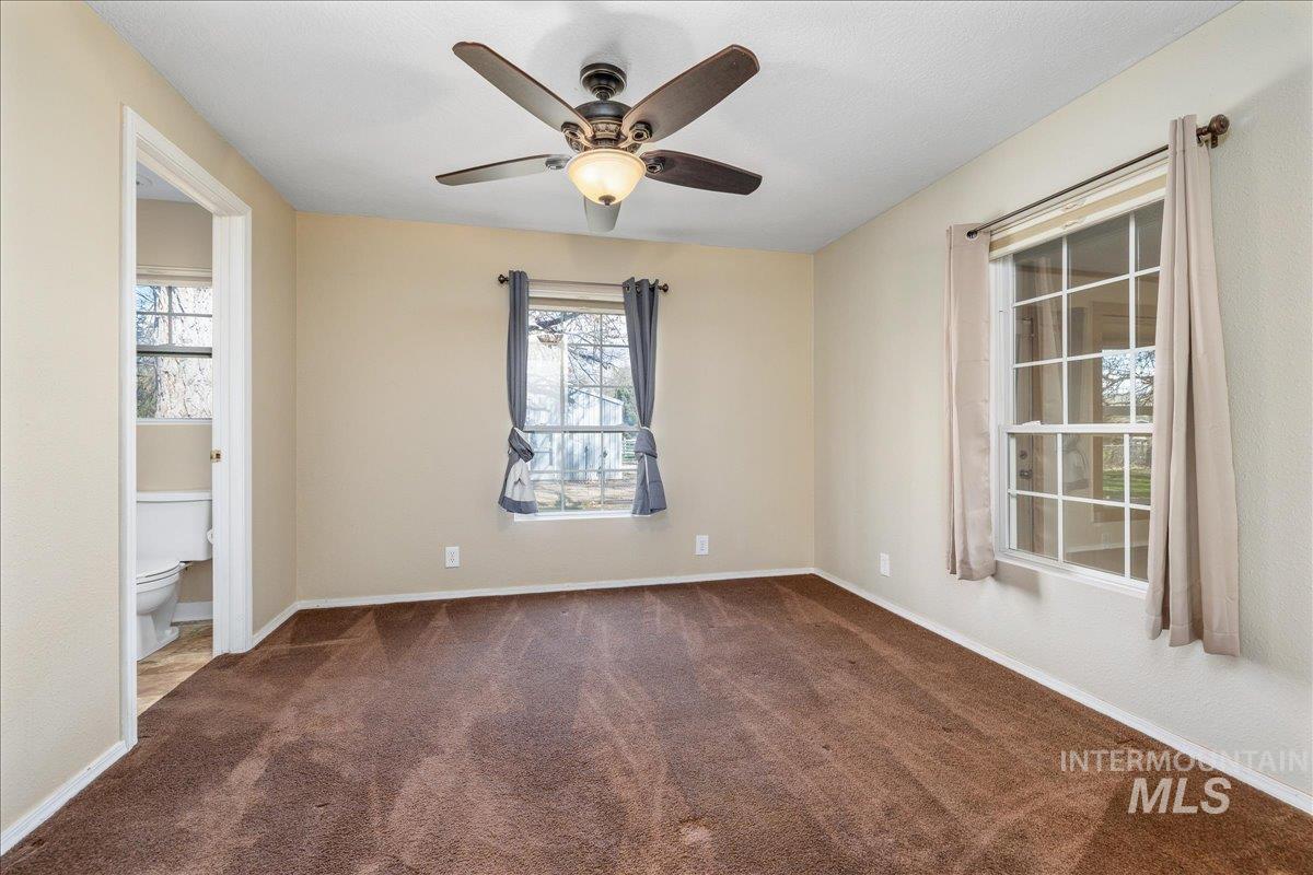 3002 Frozen Dog Road Emmett, ID 83617 - Photo 24 of 50 Unfurnished room featuring a ceiling fan and dark carpet
