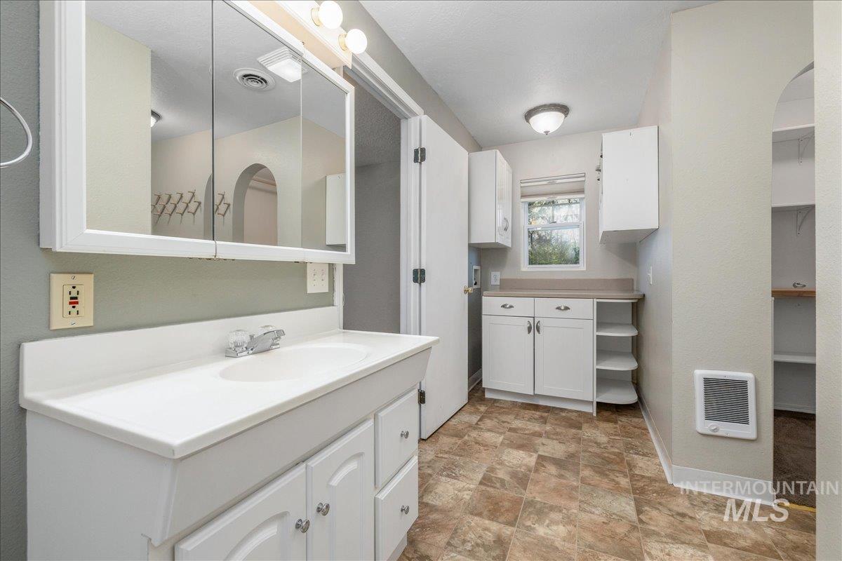 3002 Frozen Dog Road Emmett, ID 83617 - Photo 26 of 50 Full bathroom with stone finish flooring, heating unit, and vanity