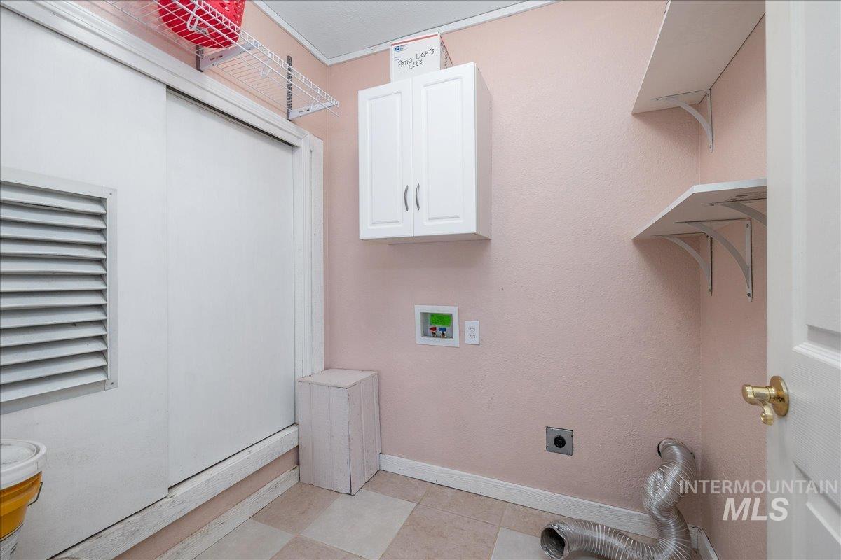 3002 Frozen Dog Road Emmett, ID 83617 - Photo 28 of 50 Laundry room featuring hookup for a washing machine, electric dryer hookup, and cabinet space