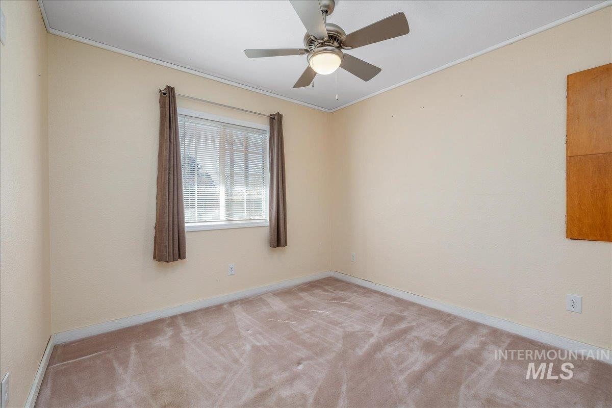 3002 Frozen Dog Road Emmett, ID 83617 - Photo 32 of 50 Unfurnished room with crown molding, light carpet, and ceiling fan