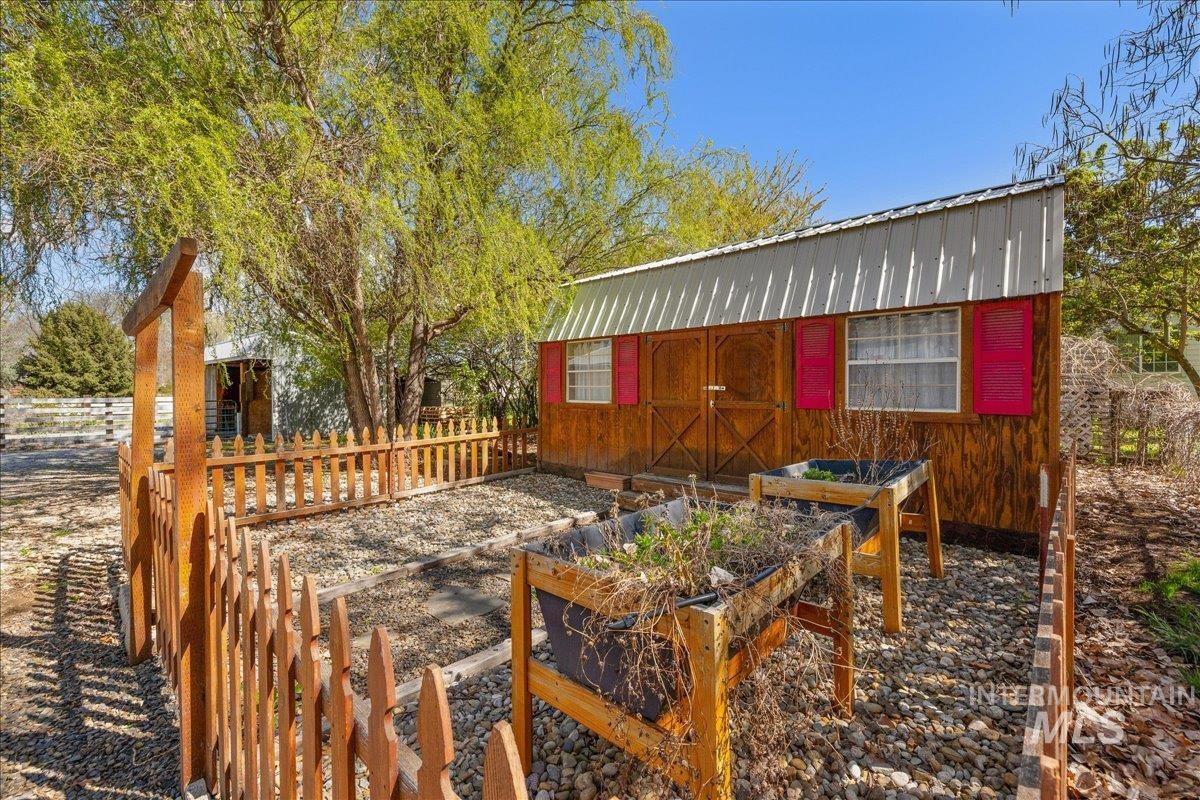 3002 Frozen Dog Road Emmett, ID 83617 - Photo 40 of 50 Wooden terrace featuring a vegetable garden and an outdoor structure