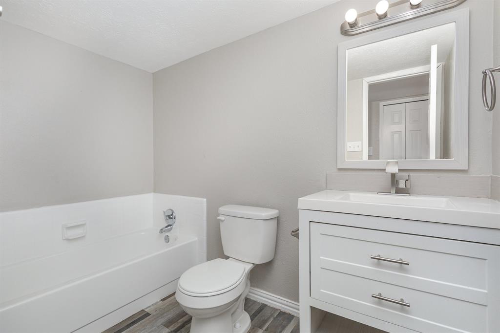 5513 Rearn Drive The Colony, TX 75056 - Photo 17 of 19 a bathroom with a sink a toilet and a bathtub