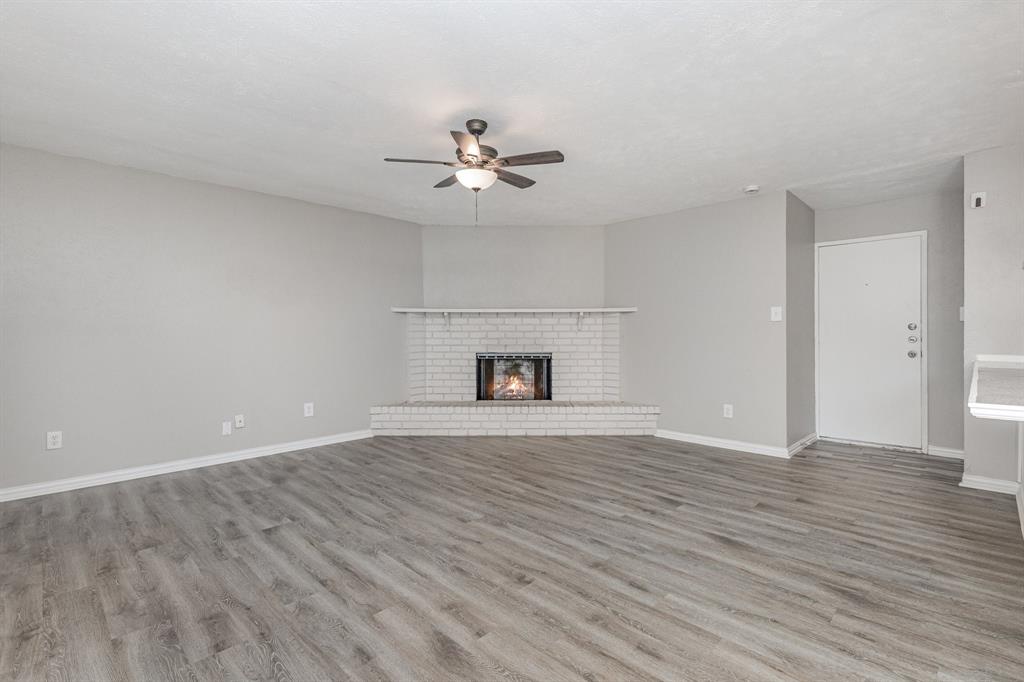 5513 Rearn Drive The Colony, TX 75056 - Photo 4 of 19 a view of empty room with wooden floor and fan