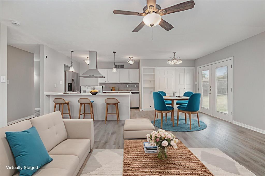 5513 Rearn Drive The Colony, TX 75056 - Photo 7 of 19 a living room with furniture and a chandelier