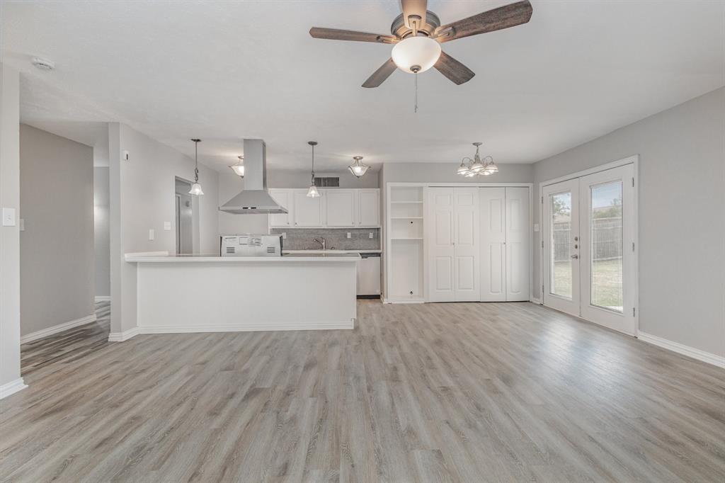 5513 Rearn Drive The Colony, TX 75056 - Photo 8 of 19 a view of a kitchen with a dishwasher cabinets and wooden floor