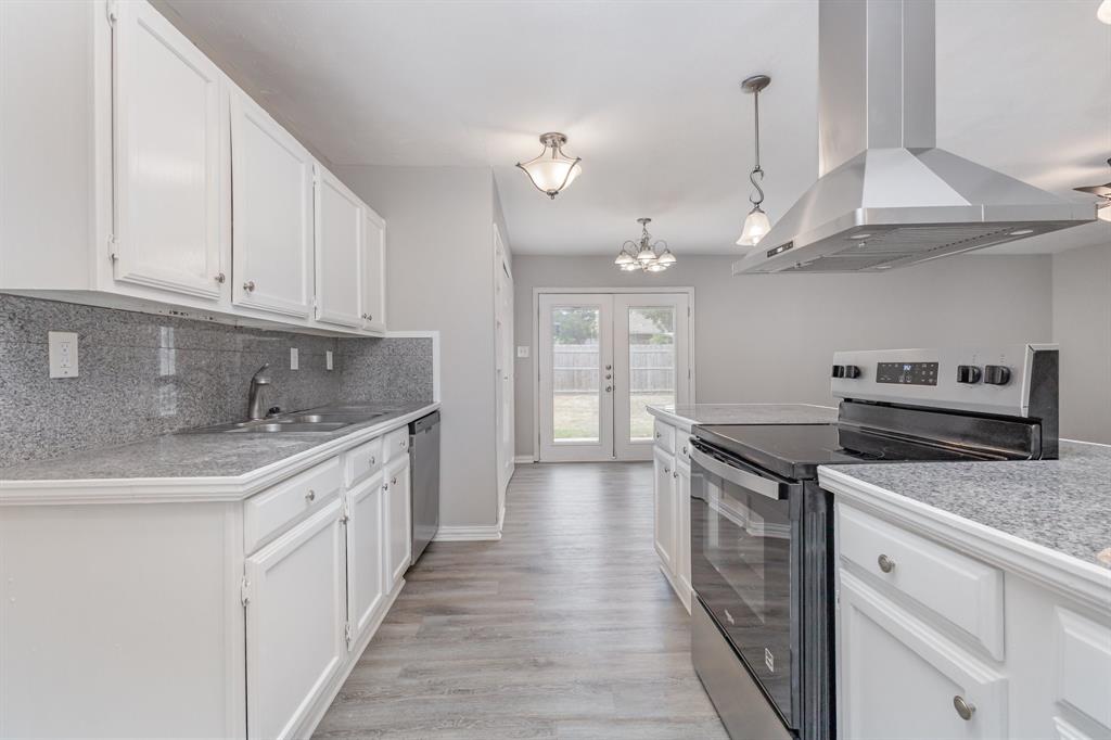 5513 Rearn Drive The Colony, TX 75056 - Photo 10 of 19 a kitchen with stainless steel appliances granite countertop a sink and a stove