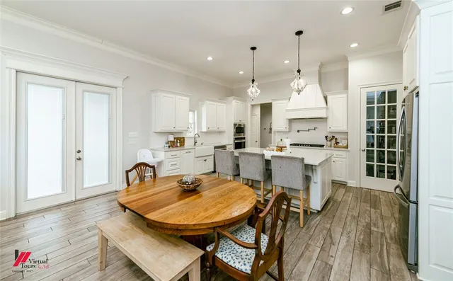 a large kitchen with a table and chairs