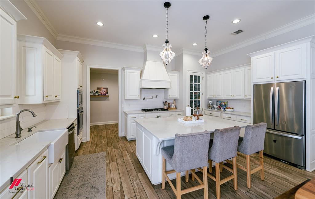 327 Ramsey Road Stonewall, LA 71078 - Photo 12 of 40 a large kitchen with granite countertop a sink a center island stainless steel appliances and cabinets