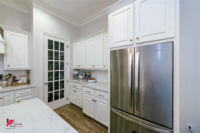 a kitchen with stainless steel appliances a refrigerator and cabinets
