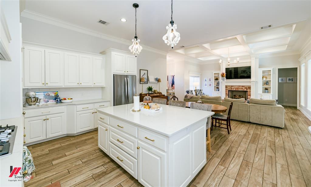 327 Ramsey Road Stonewall, LA 71078 - Photo 16 of 40 a large white kitchen with a stove a sink dishwasher and a refrigerator with wooden floor