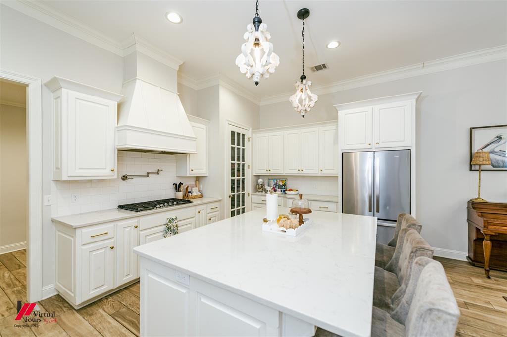 327 Ramsey Road Stonewall, LA 71078 - Photo 17 of 40 a kitchen that has a lot of white cabinets and stainless steel appliances