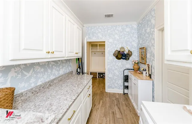 a view of a kitchen cabinets and wooden floor