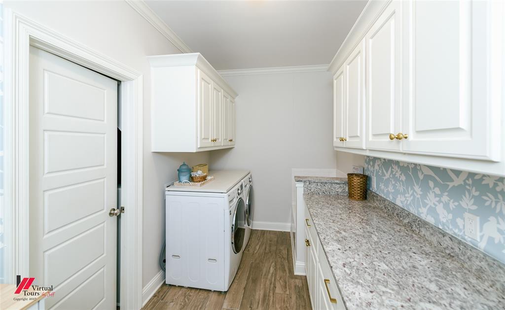 327 Ramsey Road Stonewall, LA 71078 - Photo 19 of 40 a kitchen with granite countertop white cabinets and white appliances