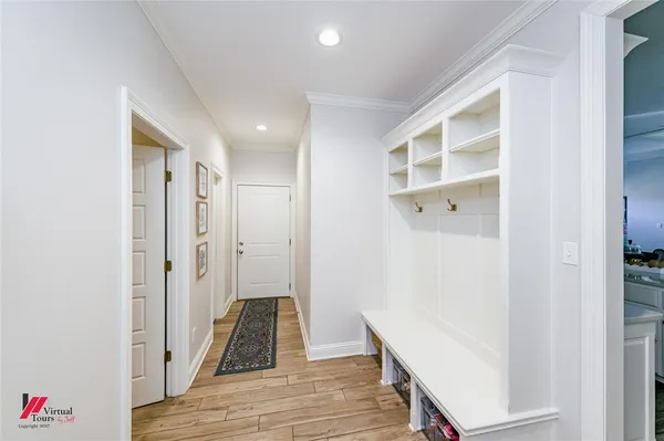 a view of a hallway with wooden floor and closet