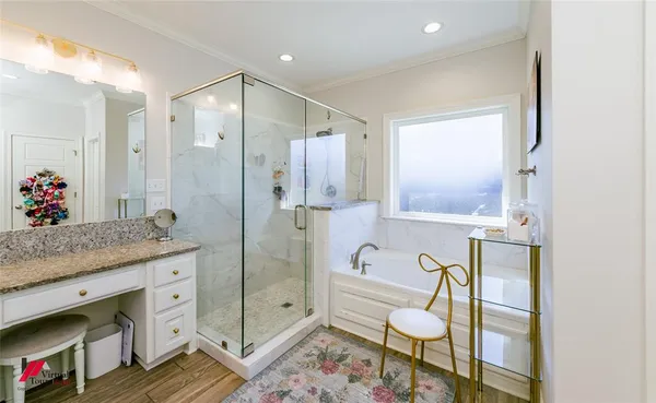 a spacious bathroom with a granite countertop sink mirror and a shower