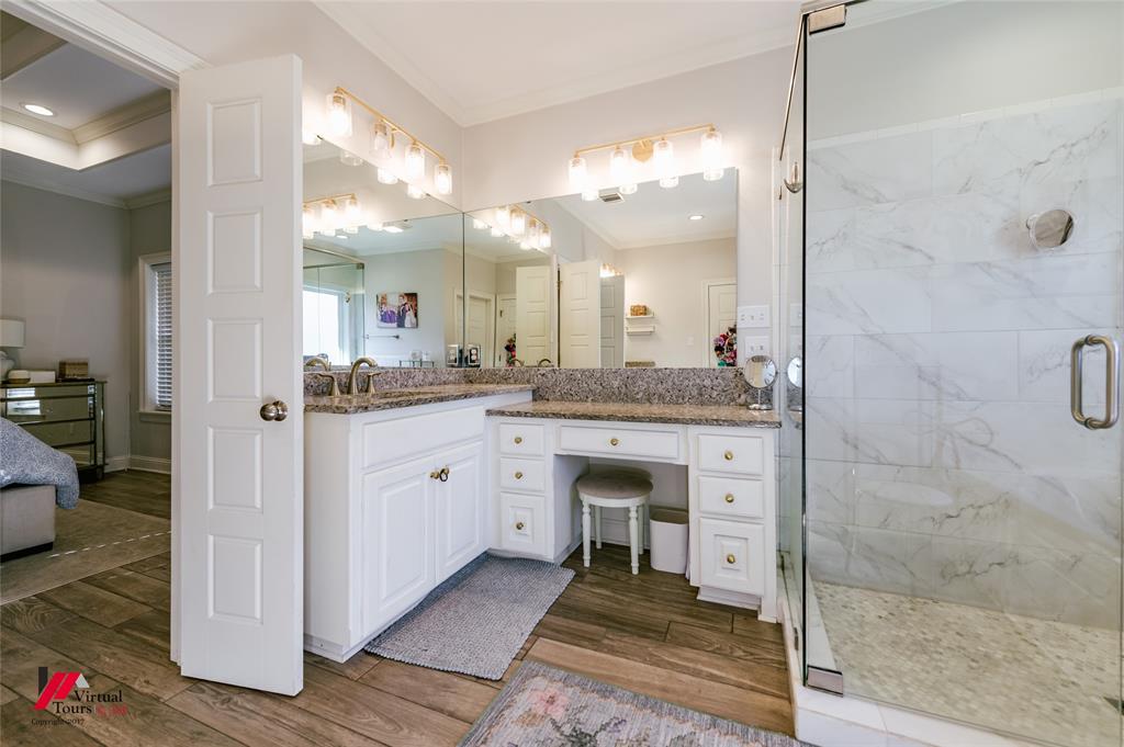 327 Ramsey Road Stonewall, LA 71078 - Photo 26 of 40 a spacious bathroom with a granite countertop sink mirror and shower