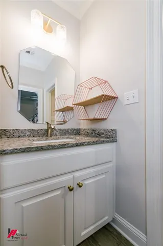 a bathroom with a granite countertop sink and a mirror