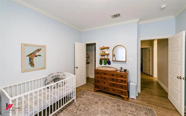 a bedroom with baby crib and furniture