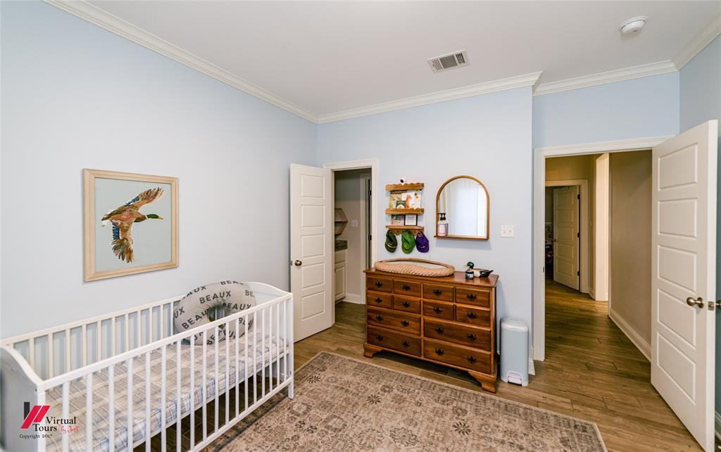 327 Ramsey Road Stonewall, LA 71078 - Photo 32 of 40 a bedroom with baby crib and furniture