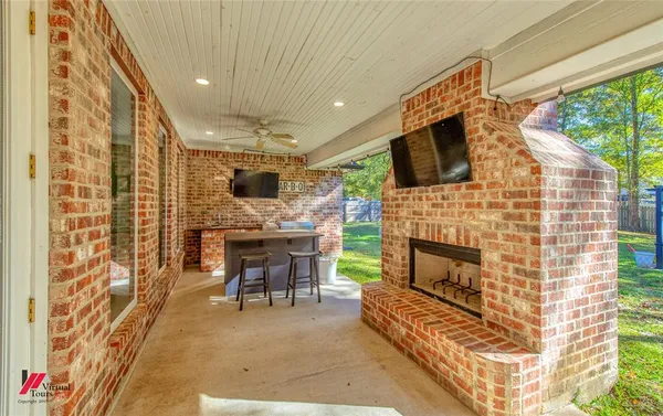 a living room with furniture a fireplace and a flat screen tv