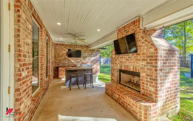 a living room with furniture a fireplace and a flat screen tv