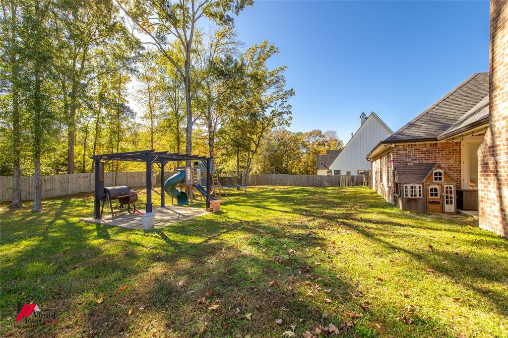 327 Ramsey Road Stonewall, LA 71078 - Photo 38 of 40 a view of swimming pool with lawn chairs and large trees