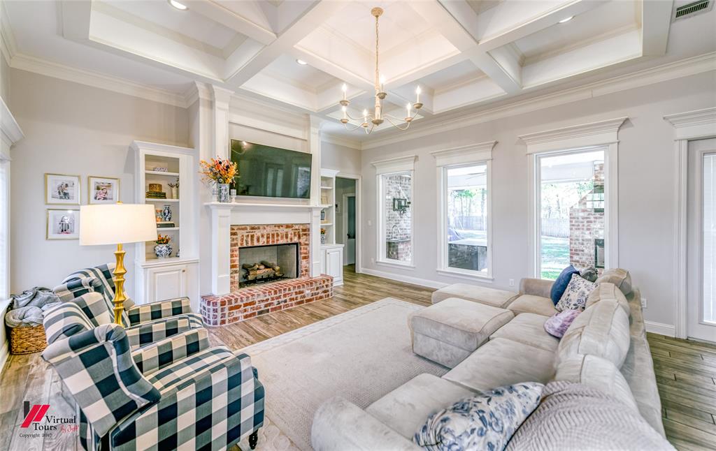 327 Ramsey Road Stonewall, LA 71078 - Photo 5 of 40 a living room with furniture a flat screen tv and a fireplace