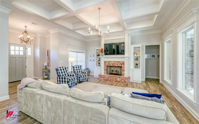 a living room with furniture fireplace and flat screen tv